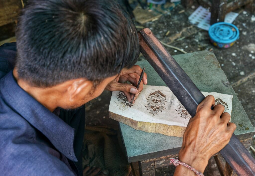 Detailed view of an artisan crafting a wooden block for textiles in Jaipur, India.