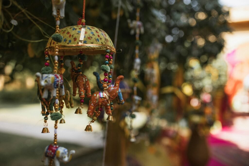 Vibrant Indian-style hanging decorations with elephants and camels in an outdoor setting.